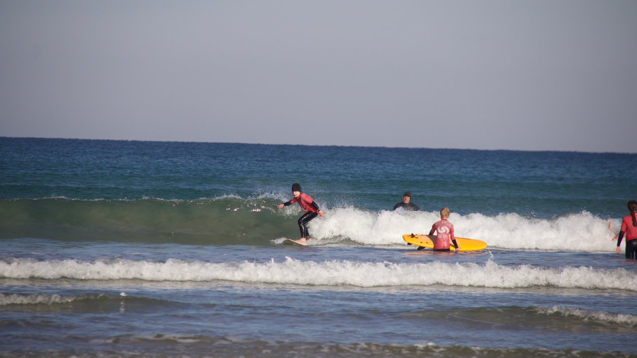 Offshore student surfing across a wave - Offshore Surf School Inverloch 