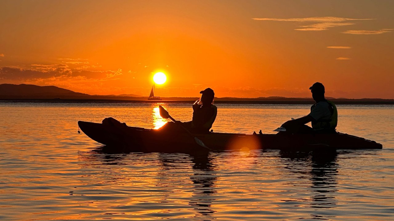 Sunset silhouettes on a guided kayak tour in 1770