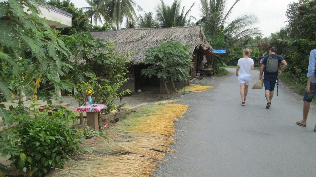 Tourists walking through local village