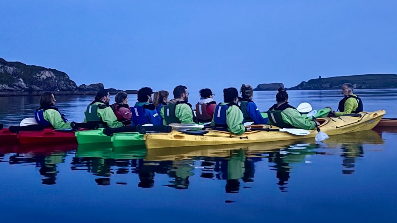 Night kayak with guide story telling in calm waters of Castlehaven