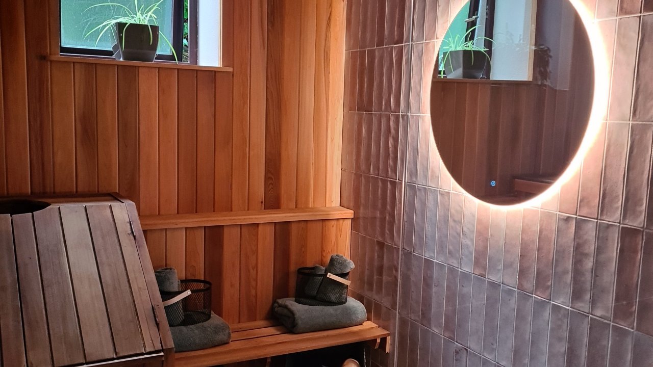 Spacious private bathroom suite with freestanding rainfall shower
