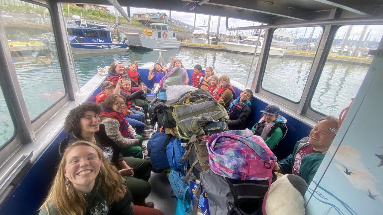 Campers and staff load the boat to depart for the Field Station.