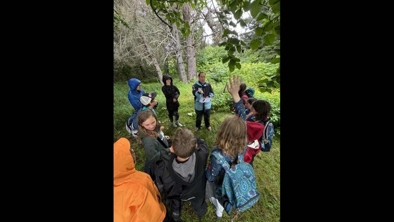 Campers answer questions in the forest around Peterson Bay.