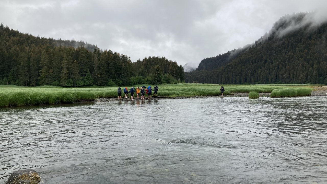 Campers negotiating a water crossing during a traverse day.