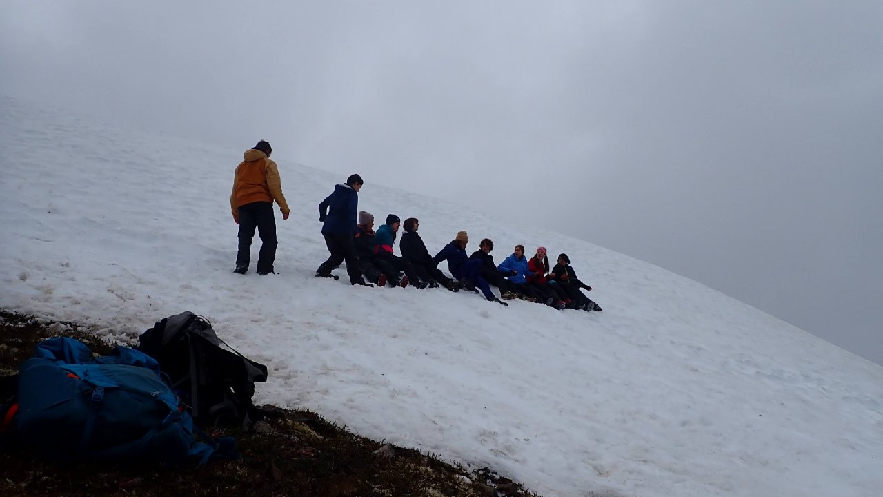 Campers group up to slide down a snow patch on Grace Ridge.