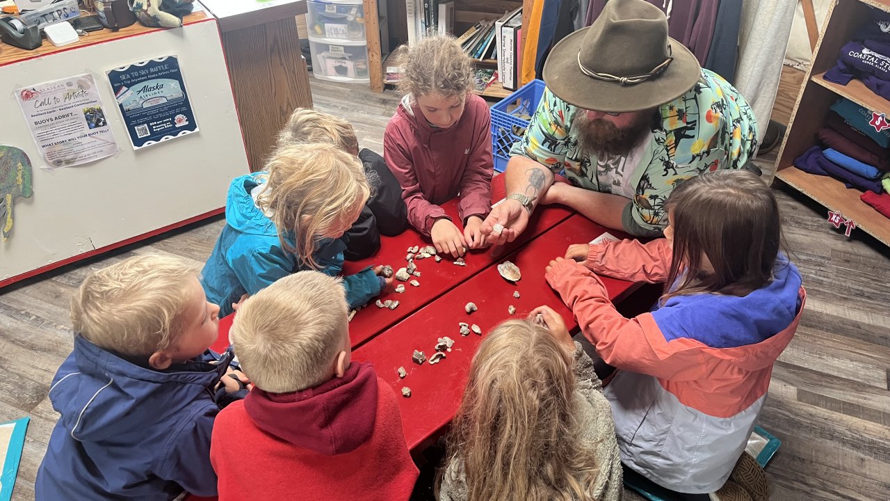 Campers get a geology lesson with rocks they've found on the beach.