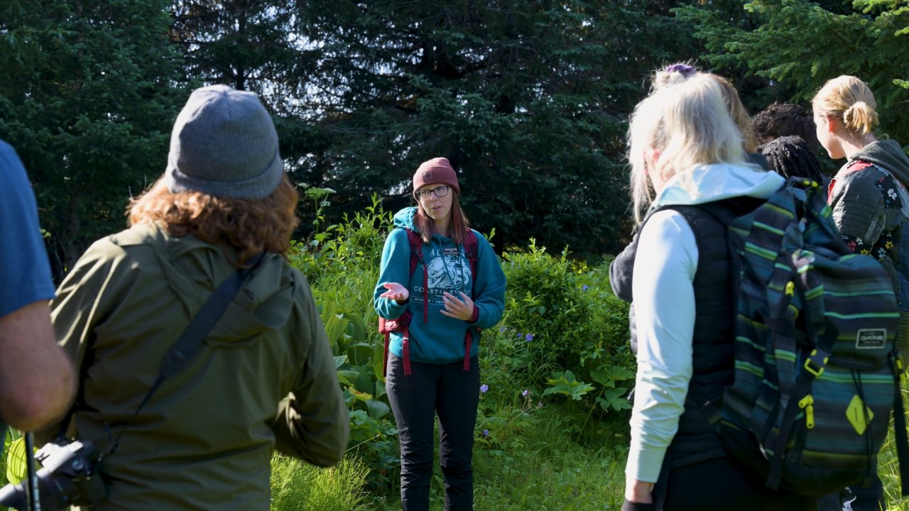 A naturalist giving interpretive information on a guided tour. Credit Twolined Studio.