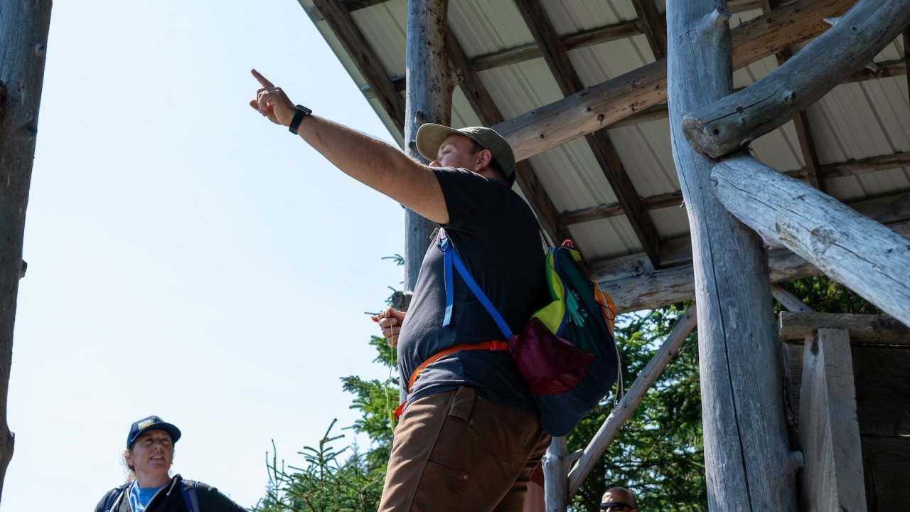 A naturalist giving a program at the Elliot Fischer Memorial Platform, overlooking a fireweed meadow. Photo by Twolined Studio.
