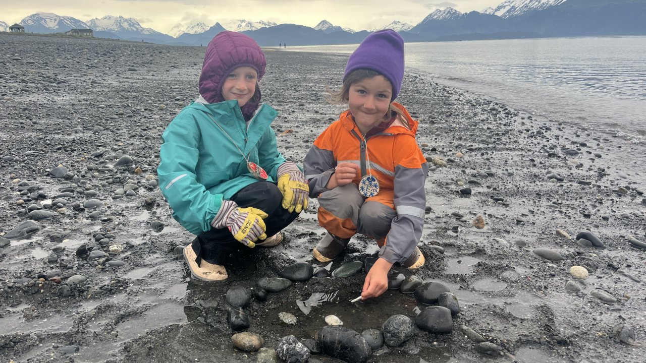 Students exploring rock on the Spit, in Homer