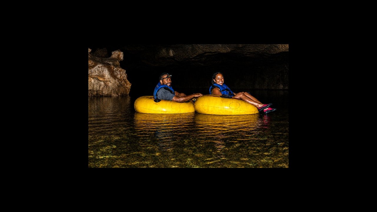 Guests cave tubing inside a Belize river cave
